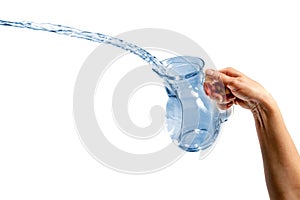 Hand pouring water from glass jug