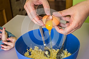 Hand pours out raw egg of the shell