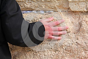 Hand of praying man on the Western Wall