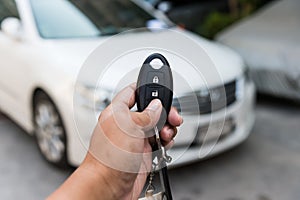 A hand press button of remote control car key to open a car door