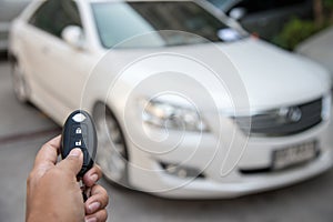 A hand press button of remote control car key to opens a car door.