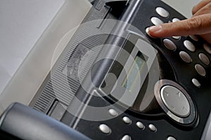 The Hand Presses The Fax Button