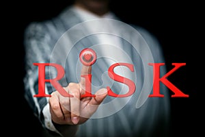 Hand presses the red button in the word risk, risk management concept, loss insurance, risk hedging