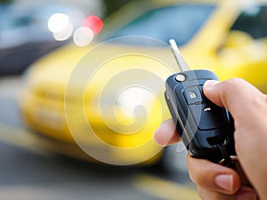 Hand presses on the remote control car alarm systems.