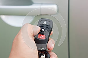 Hand presses on the remote control car alarm