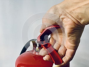hand presses the trigger fire extinguisher