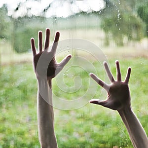 Hand pressing against window