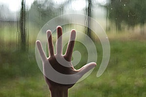 Hand pressing against window