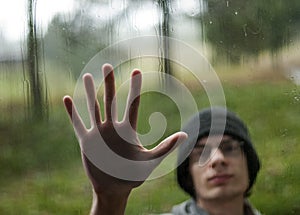 Hand pressing against window