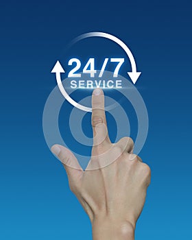 Hand pressing button 24 hours service icon on blue background, F