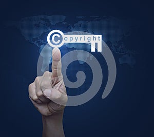 Hand pressing copyright key icon over digital world map technolo