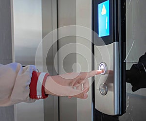 hand pressing on elevator button