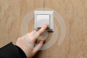 Hand Pressing Light Switch