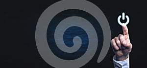 Hand pressing power button.