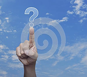 Hand pressing question mark sign icon over sky