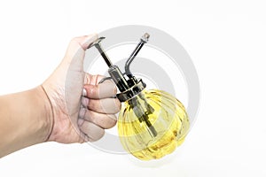 Hand pressuring yellow spray glass bottle isolate