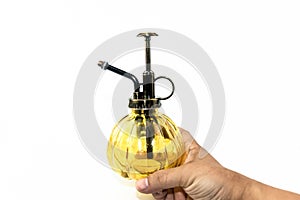 Hand pressuring yellow spray glass bottle isolate