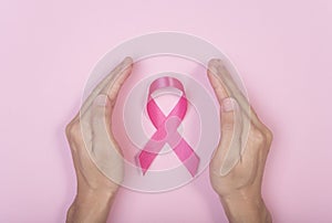 Hand prevent pink ribbon breast cancer on pink