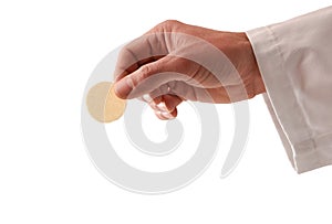 Hand of a priest with consecrated host and white background photo