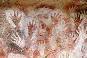 Hand prints on a cave wall cueva de las manos photo