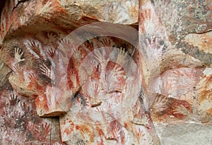 Hand prints on a cave wall cueva de las manos photo