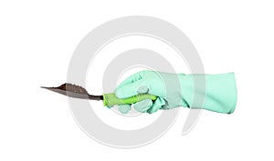 A hand in a protective glove holds a garden shovel with soil. Isolated on white with saved path.