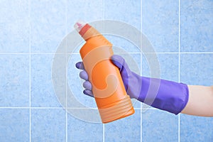 Hand protective glove. Household chemicals in hand. Blue tile background
