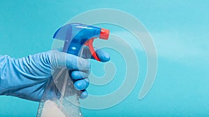 Hand in protective glove spraying disinfectant photo