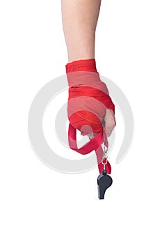 Hand with protective red bandages holds a whistle isolated on a white background