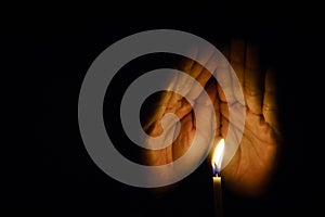 The hand that protects the candles in the dark