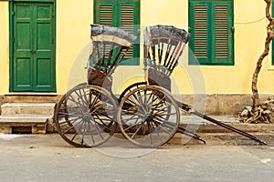 Hand pulled rickshaws are parkedon the street. Kolkata. India