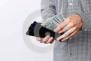 Hand pulling 100 dollars banknotes