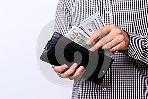 Hand pulling 100 dollars banknotes