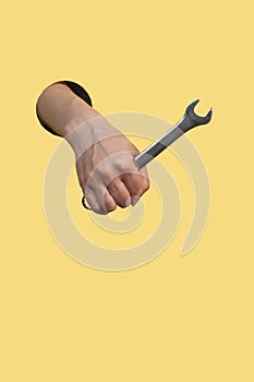 A hand pulls out a wrench