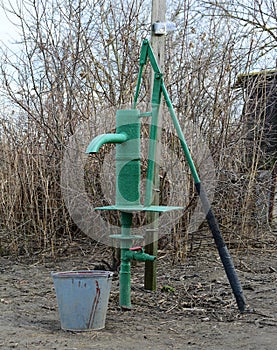 Hand pump leading to an artesian well.