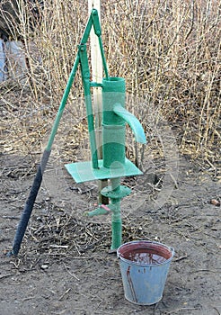 Hand pump leading to an artesian well.