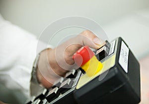 Hand pushing the button on the control panel