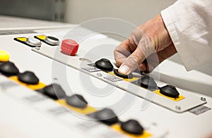 Hand pushing the button on the control panel