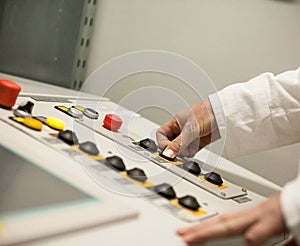 Hand pushing the button on the control panel