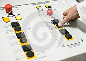 Hand pushing the button on the control panel