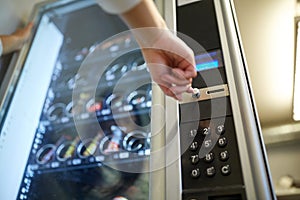 Hand pushing button on vending machine