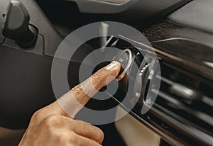 Hand pushing on the dashboard of automobile