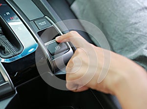 Hand pushing electric handbrake, Modern car interior