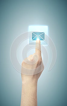 Hand pushing email button