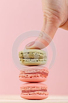 Hand pushing on macaroons