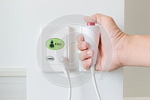 Hand pushing nurse call button