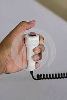 Hand pushing nurse call button