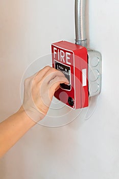 Hand pushing the push in pull down switch fire