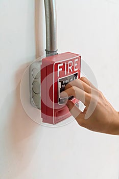 Hand pushing the push in pull down switch fire