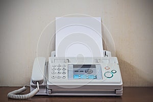 A hand pushing start button old fax